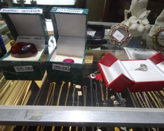 Thats a lg piece of Ruby Red Clear Baltic Amber next to a Fiery Pink Diammond Cut Oval Citrine & to the Righta Spectacular (and Somewhat Rare) 5 carat crystal clear topaz set in sterling