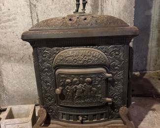Ornate Antique Cast Iron Stove with Decorative Soldier Finial