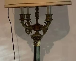 Hollywood Regencystyle black pedestal and brass column candelabra table lamp.