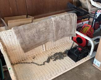 Antique white wicker porch swing 