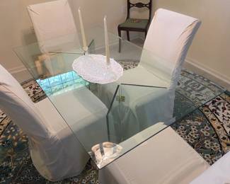 Glass dining table with 4 slipcovered chairs