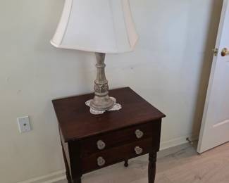 Mahogany 2-drawer nightstand with glass pulls, table lamp, art