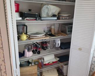 Kitchen pantry with small appliances, coffee maker, cookware