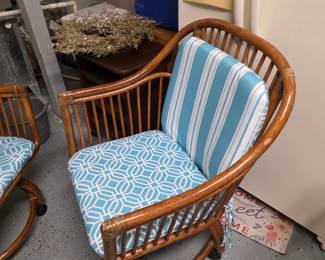 Vintage rattan rolling armchair, aqua striped and geometric cushions