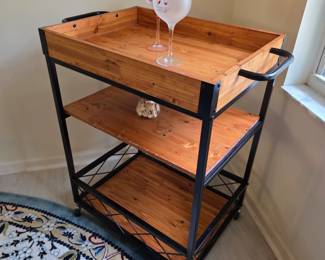 Rolling 3-tier bar cart, wood and black metal, with wine glasses