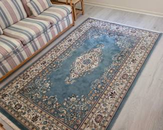 Persian-style area rug, blue medallion design, ivory border