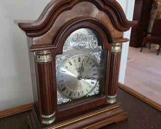 Burl wood mantel clock with silver dial and brass columns
