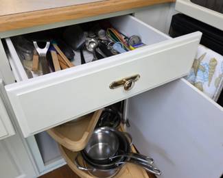 Kitchen utensil drawer and corner lazy Susan with pots and pans