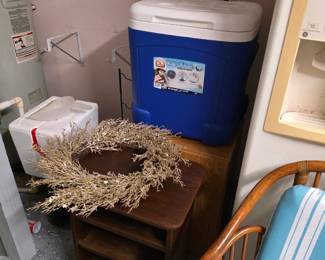 Blue rolling cooler, white cooler, gold holiday wreath, wood cart