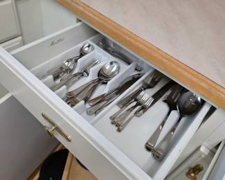 Kitchen drawer with stainless flatware in organizer tray