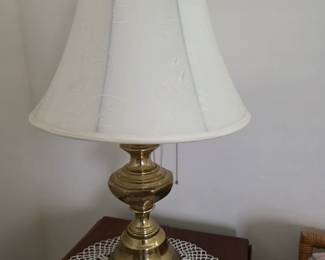 Solid brass trumpet-base table lamp with cream bell shade