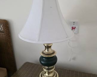 Brass table lamp with dark green accent and white shade
