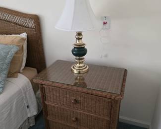 Wicker 3-drawer nightstand with glass top, brass and green lamp