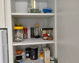 Kitchen cabinet with spices, pantry staples and cooking oils