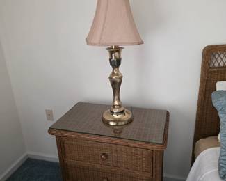 Wicker 3-drawer nightstand with glass top and brass lamp