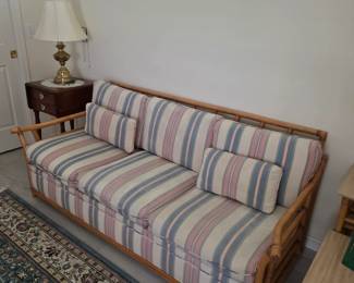 Vintage bamboo-frame sofa with pastel striped cushions