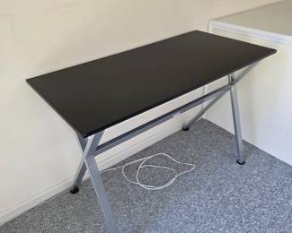Black desk with silver metal X-frame legs