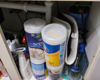 Under-sink cabinet with cleaning supplies and disinfecting wipes