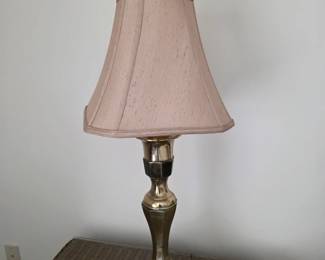 Brass table lamp with blush shade and decorative medallion finial