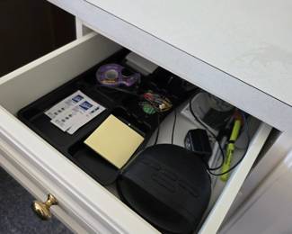 White built-in desk drawer with assorted office supplies