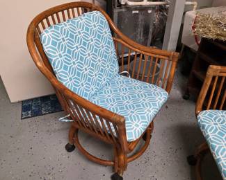 Vintage rattan rolling armchair with aqua geometric cushions