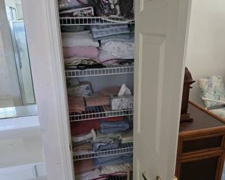 Linen closet stocked with bed linens, towels and blankets