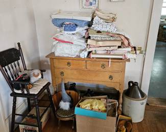 Old jugs, antique pressed wood high chair, child's barrel rocking chair, old linend and needlework, antique ice skates, wooden shoe stretchers, sideboard table