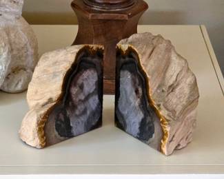 Pair of polished geode bookends with natural stone exteriors and contrasting banded interiors.