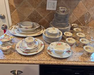 Haviland Limoges floral china with blue edging and gold handles, including dinnerware and serving pieces.
