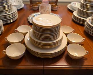 Lenox Wheat china with gold wheat decoration and gold rims, including plates, bowls, cups and saucers.