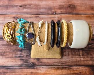 Vintage costume bracelets and bangles in assorted colors, textures and decorative styles.