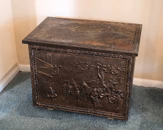 Brass repoussé coal box with decorative raised scenes and hinged lid — vintage fireplace accessory.