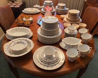 Noritake Rosalie 3052 china with pink rosebuds and gold trim, including plates, cups, saucers and serving pieces.