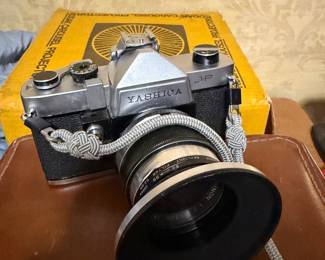 vintage silver and black Yashica J-P 35mm film SLR camera equipped with a lens