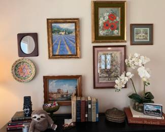 Framed floral and landscape prints with round wall mirror