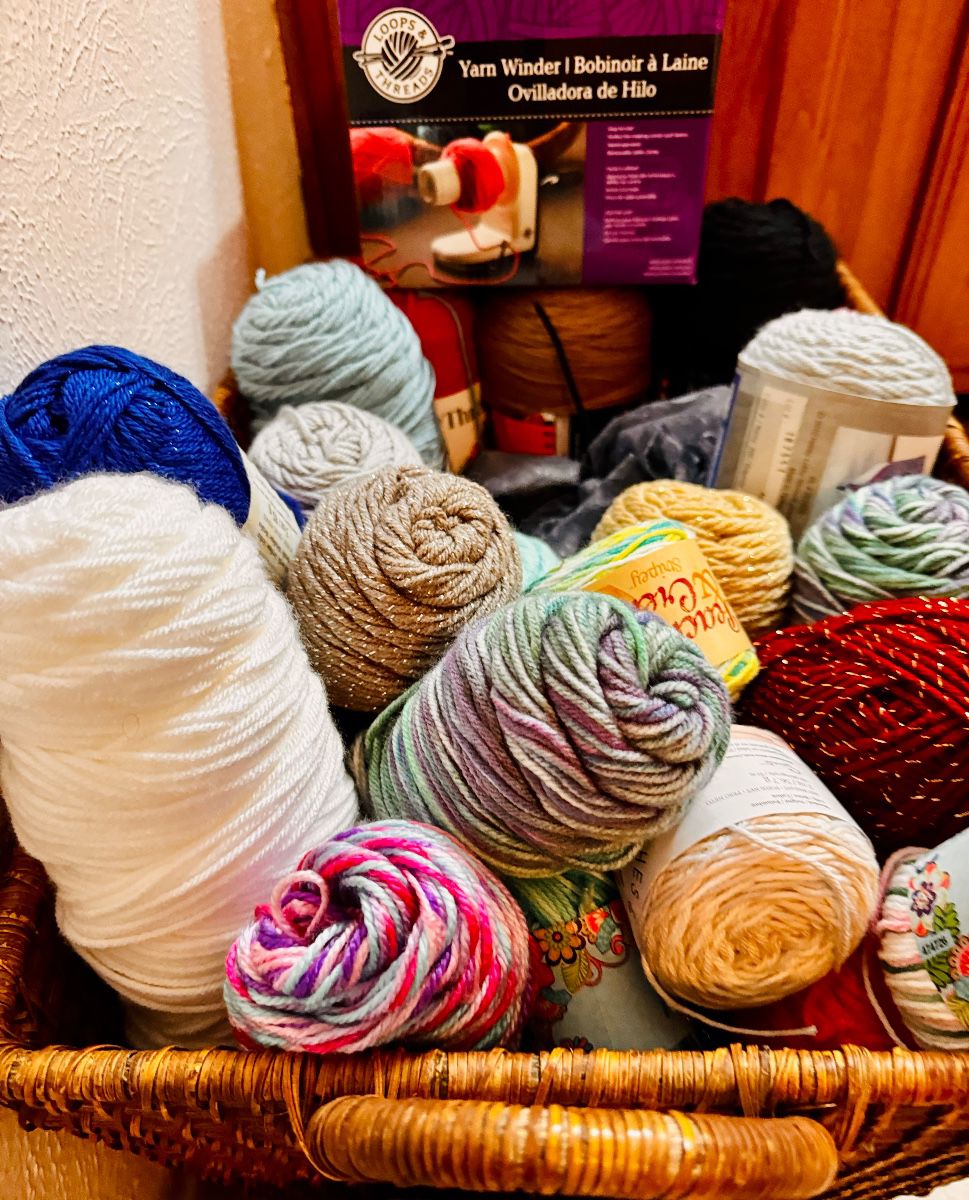 Basket of yarn and knitting supplies