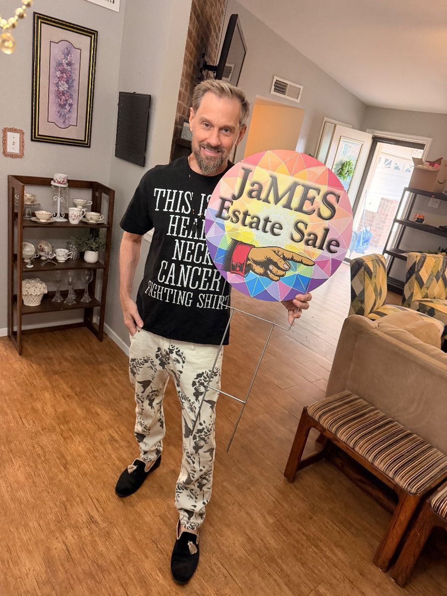 James Major holding a James Major Estate Sales sign at the Euless sale