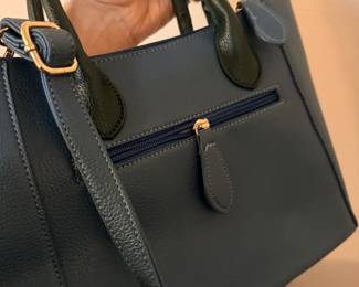 Back side of the blue purse worth rose embellishment