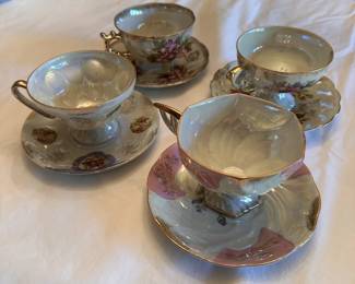 Vintage opalescent porcelain tea cups with saucers