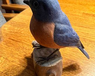 Bluebird or songbird perched on a log