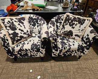 black-and-white cow print club accent chairs