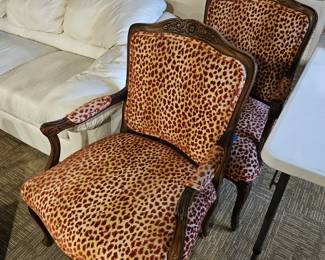 French Louis XV-style carved wood armchairs with leopard print upholstery
