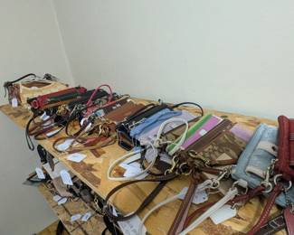 Purses in many styles including clutch, wristlet, crossbody, hobo, and backpack, including brand names Coach, Fossil, Michael Kors, Kate Spade, Mimeo, many leather purses, and others as well!