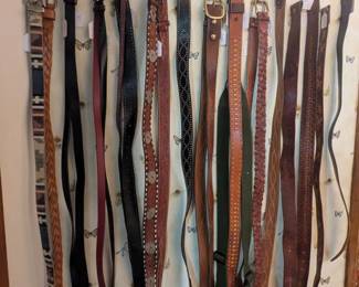 Belts for both men and women, many leather and some fashion, including belt buckles