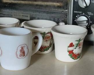 Collectible Holiday & Character Mugs: Set of vintage milk glass mugs featuring Santa Claus holiday graphics and retro novelty character prints.