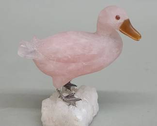 527 Carved rose quartz duck figure mounted on a