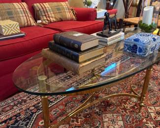 Red loveseat, brass and glass coffee table, Oriental rug, 