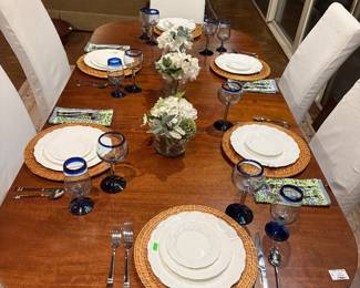 Mid century modern mahogany table, 6 slipcovered chairs, rattan chargers, Wedgwood China, 