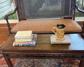 Caneback loveseat, narrow Asian  coffee table,