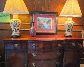 A vintage mahogany serpentine sideboard made by the Drexel Furniture Company.